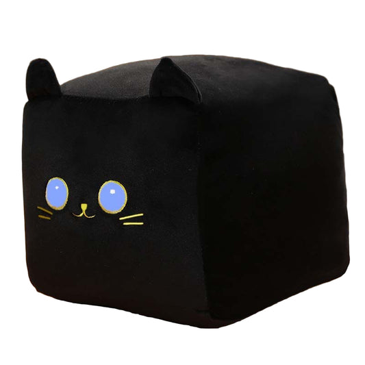 Black cat-shaped cushion with cute face design on a wooden surface