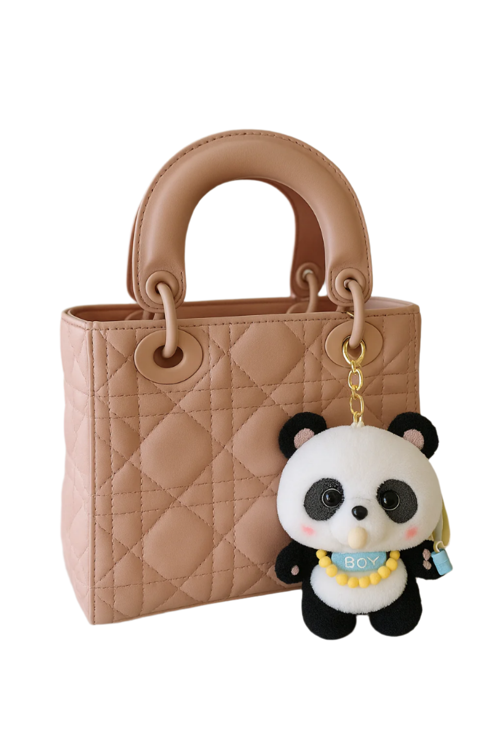 Quilted beige handbag with a panda keychain on a light surface