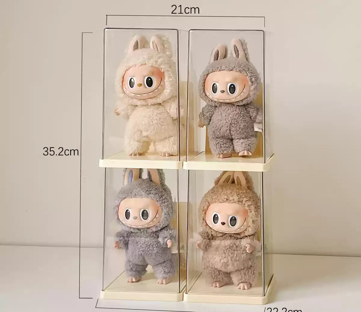 Four plush toys in clear display cases with measurements on a light gray background