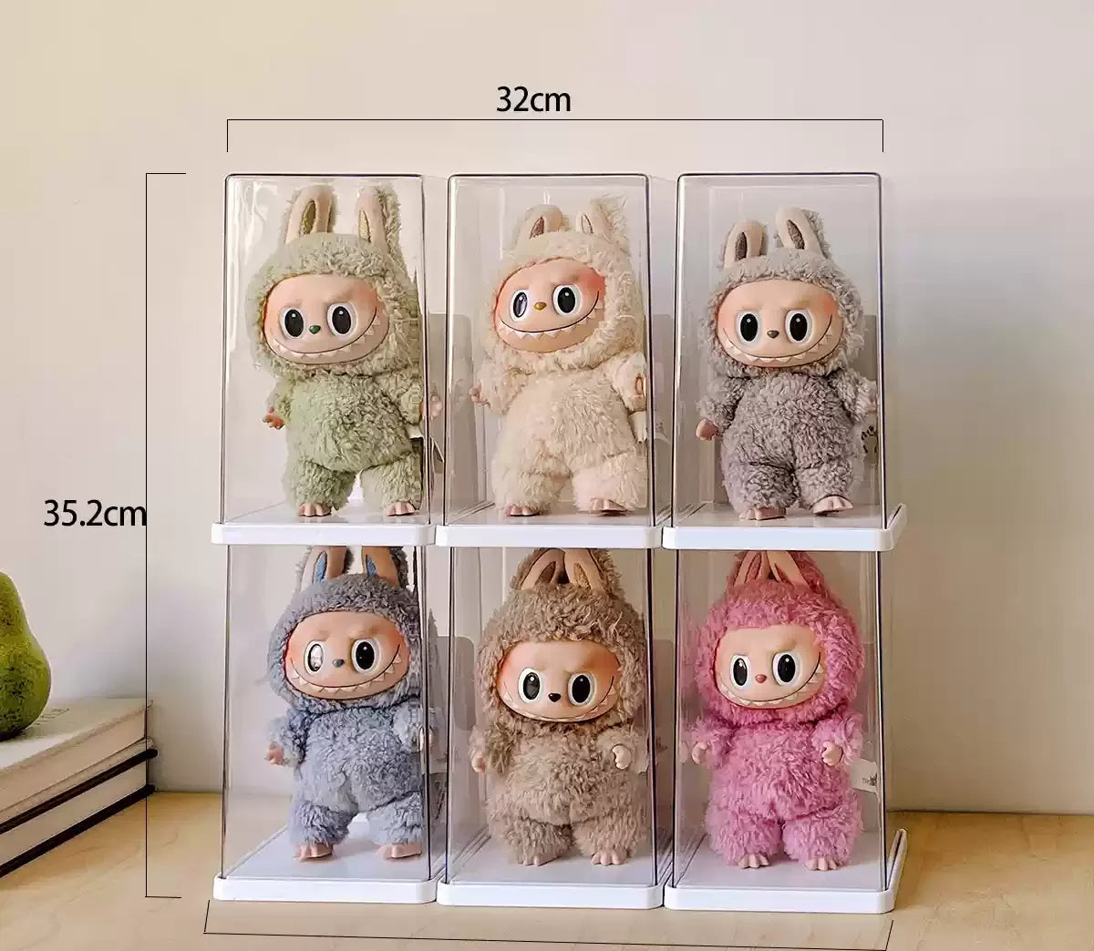 Set of five plush toys in clear display cases with measurements on a neutral background