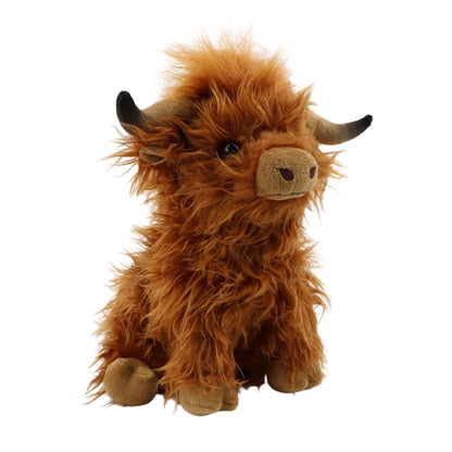Plush toy cow with brown fur on a white background