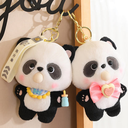 Two panda plush keychains with accessories on a wooden surface.