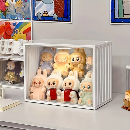 Collection of cartoon-themed figurines in a clear display case with colorful artwork in the background.