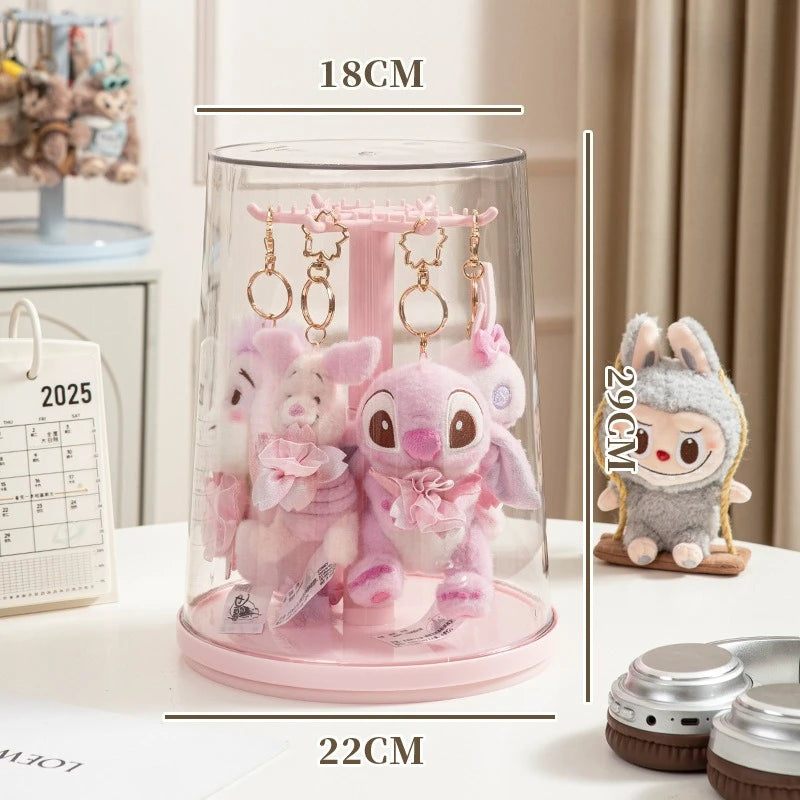 Pink plush toy with keychain in a glass display case, with measurements shown.