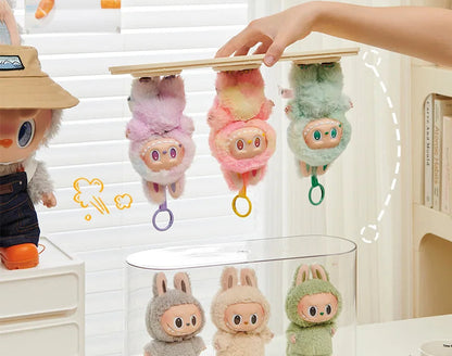 Plush toys hanging from a wooden stand with a blurred background