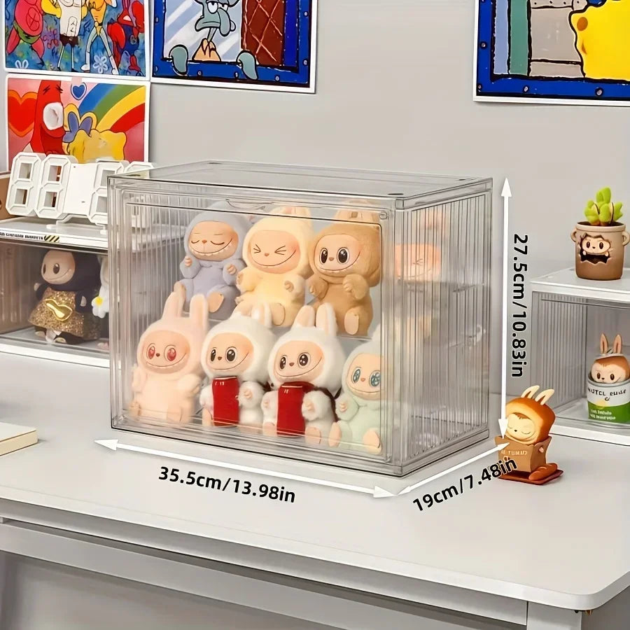 Clear acrylic display case with cartoon figurines on a shelf, showing dimensions.