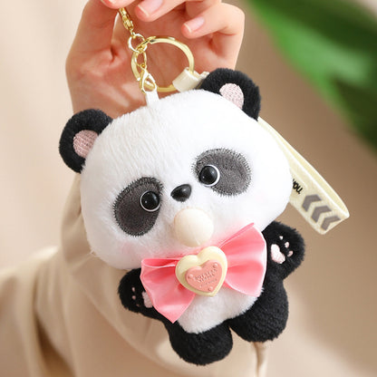 Plush panda keychain with a pink bow held by a hand against a neutral background