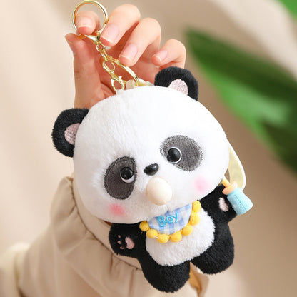 Plush panda keychain held by a hand against a neutral background